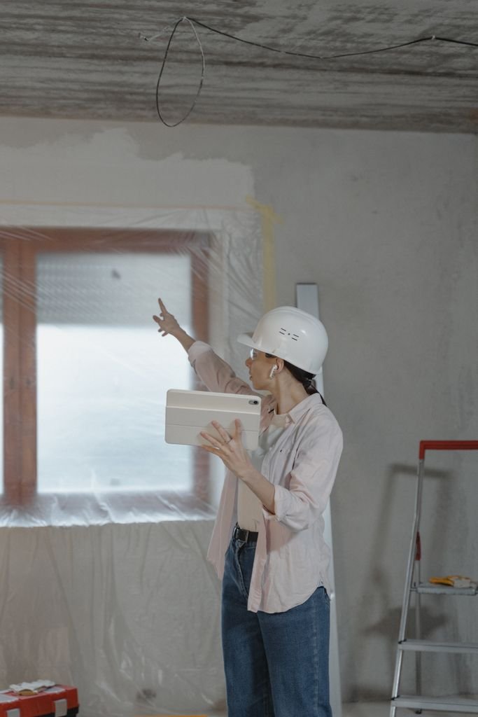 Technician reviews a job on a tablet at a customer's home — FieldEdge review