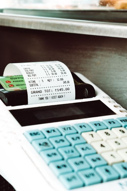 Close-up of a cash register printing a receipt