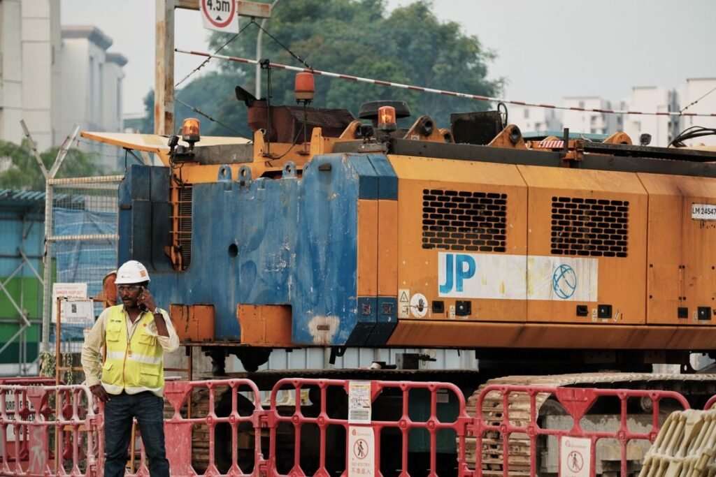 Construction worker on the phone at an urban project site