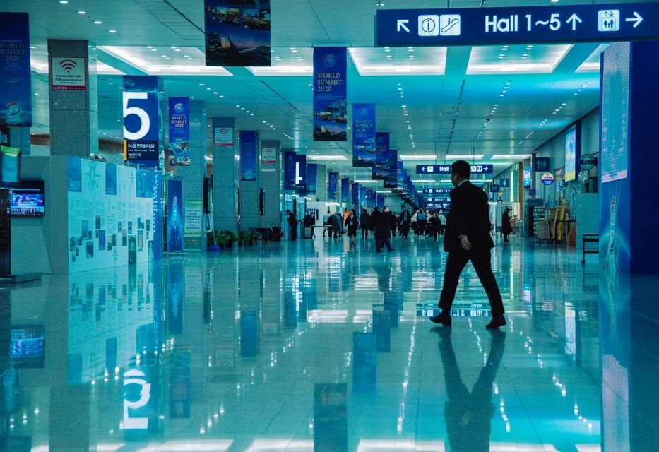 Attendees walking through a convention hall corridor between exhibit halls