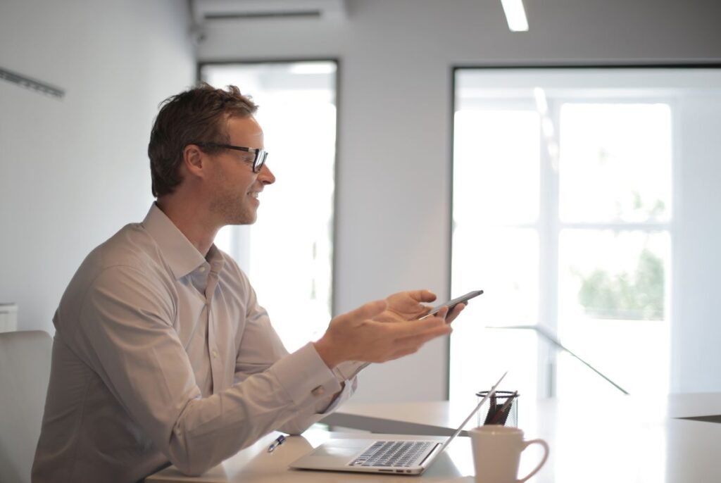 Business owner at a table with a smartphone and laptop gadgets