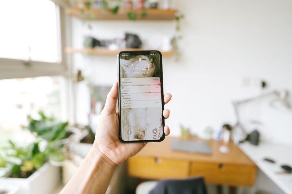 Hand holding a smartphone with missed-call text-back message notifications on screen