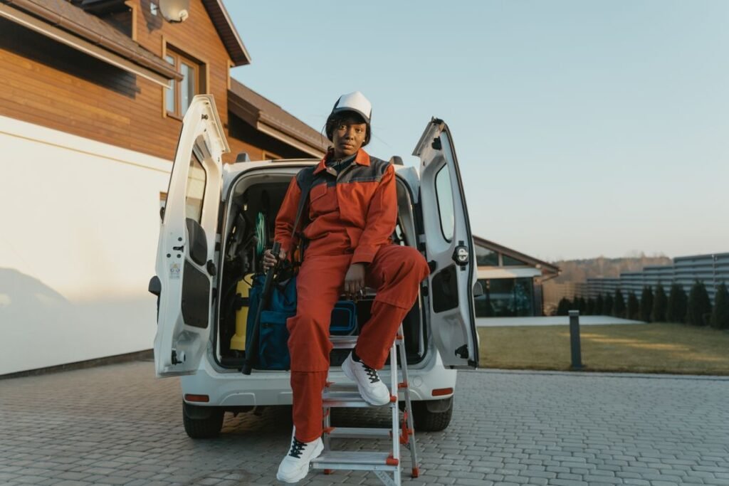 Field technician preparing tools at the open rear doors of a white service van, illustrating the field-operations side of this GoHighLevel vs Jobber vs Housecall Pro comparison