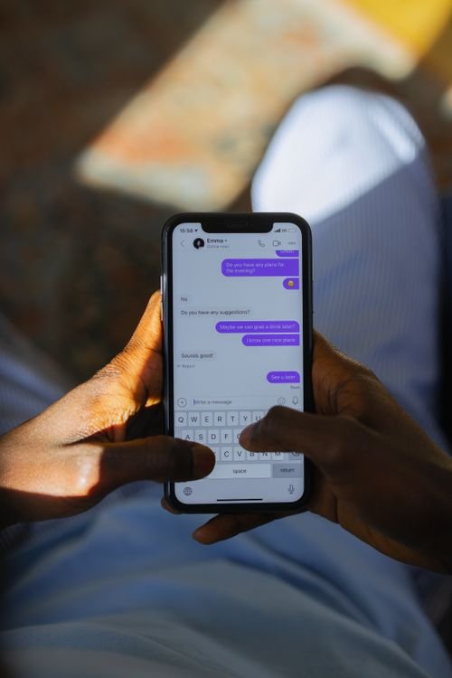 Close-up of a person texting on a smartphone with the chat screen in focus