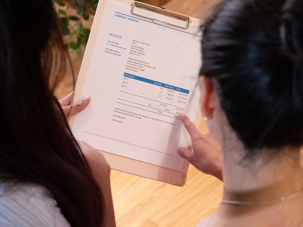 Two people reviewing an invoice together
